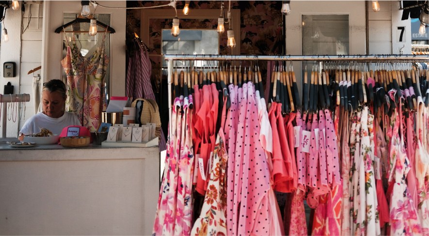 Racks of coastal clothing inside a local shop