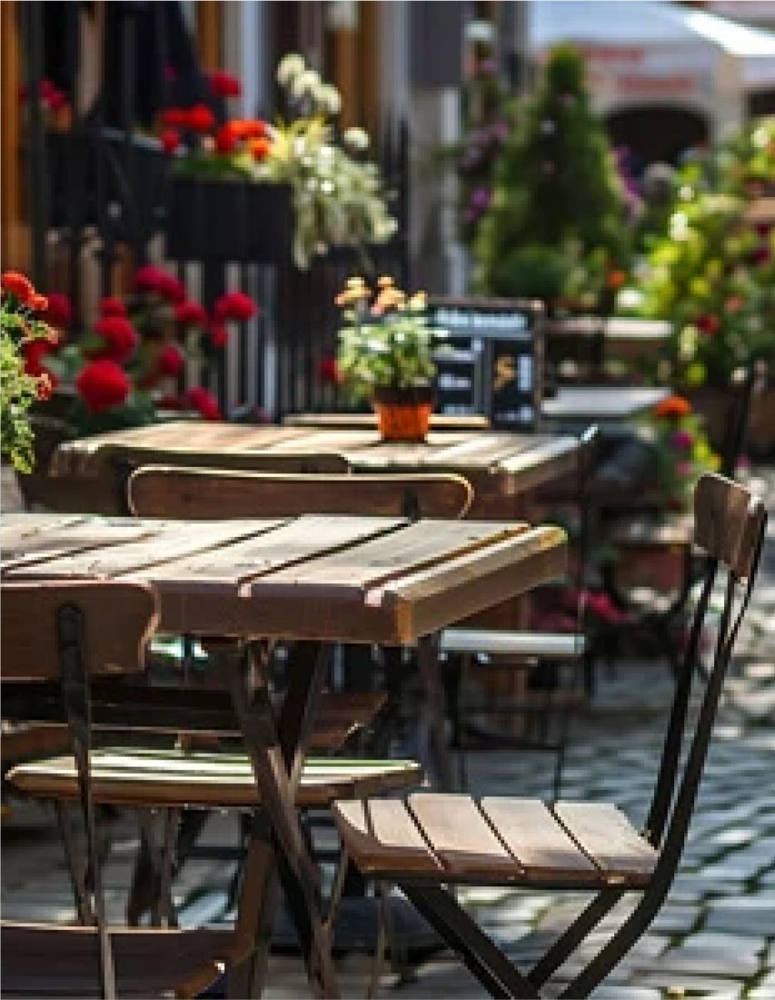 Bistro tables set out under flowering planters