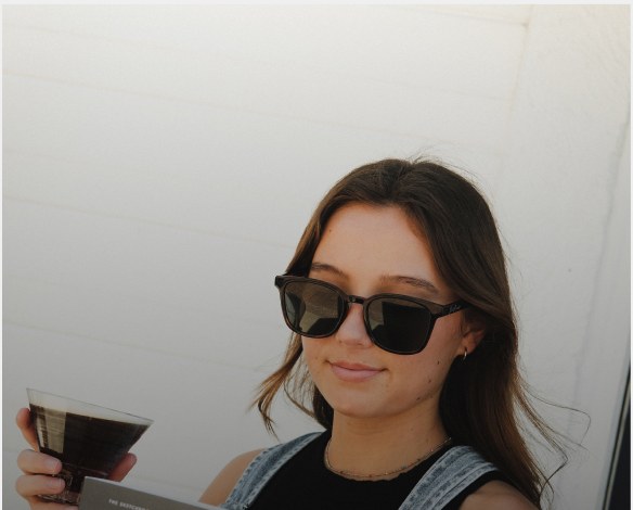 A guest with an iced drink in the sun